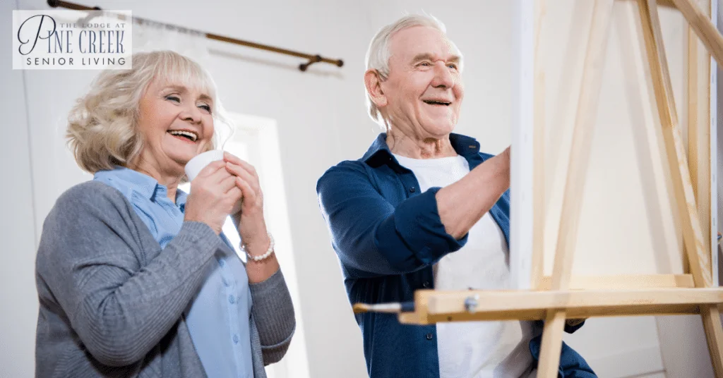 A happy senior couple is painting a picture. Memory care activities for seniors with dementia.
