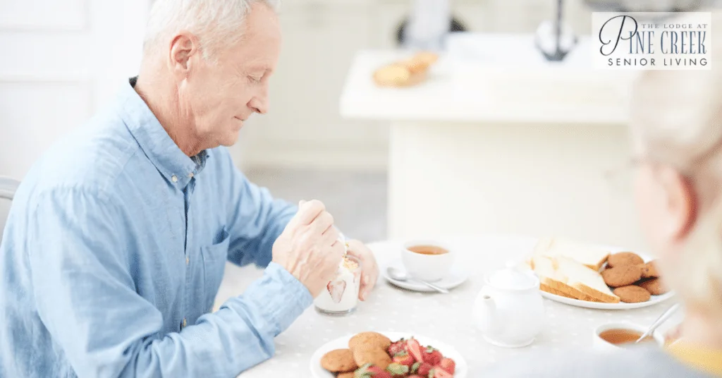Memory care dining. A senior man is eating the dessert