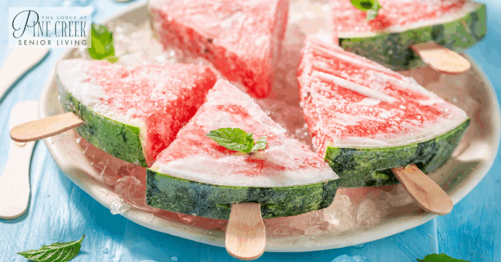 A plate of frozen watermelon slices on sticks, resting on ice. This refreshing and hydrating treat is perfect for caring for people with dementia during hot weather, helping to prevent dehydration and promote comfort.